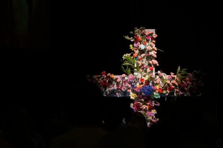 Cross covered in spring flowers.